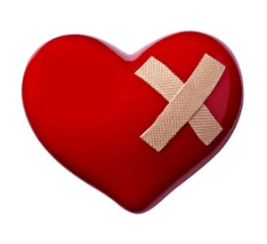 close up of a heart shape with bandage on white background
